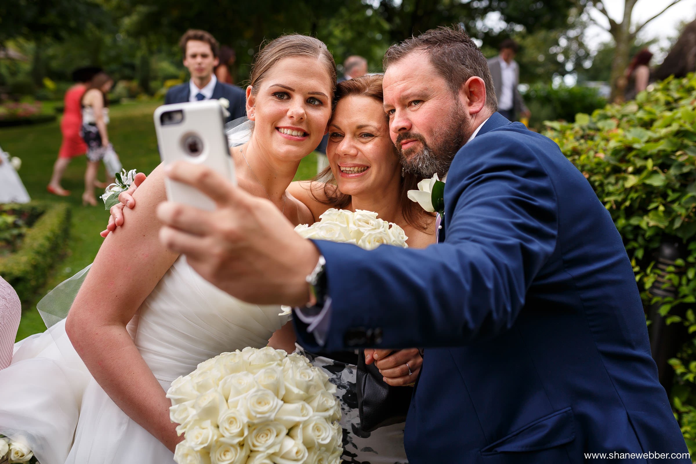 Natural wedding photo of guests taking a selfie