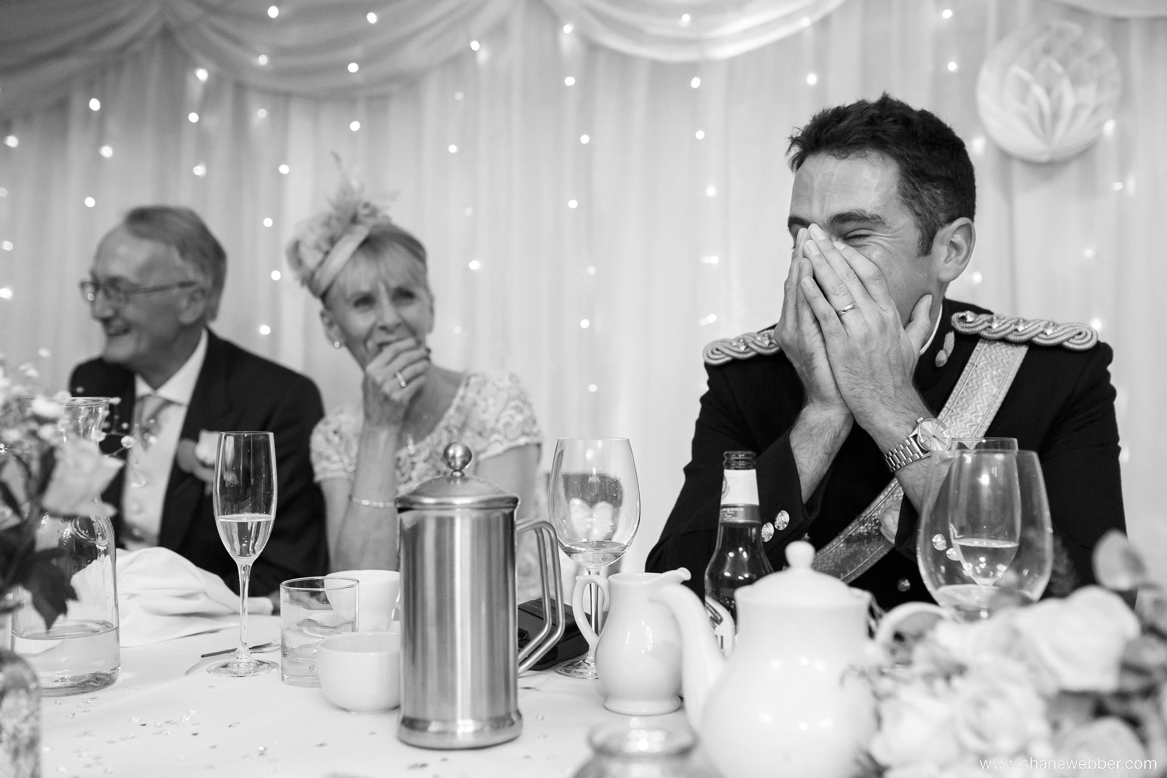 Black and white wedding photo during speeches
