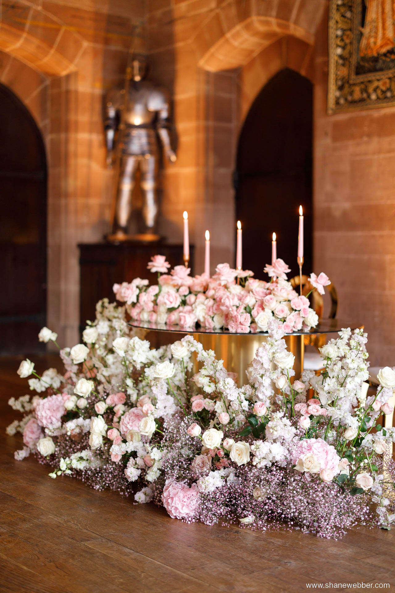 Pink wedding ceremony flowers and candles