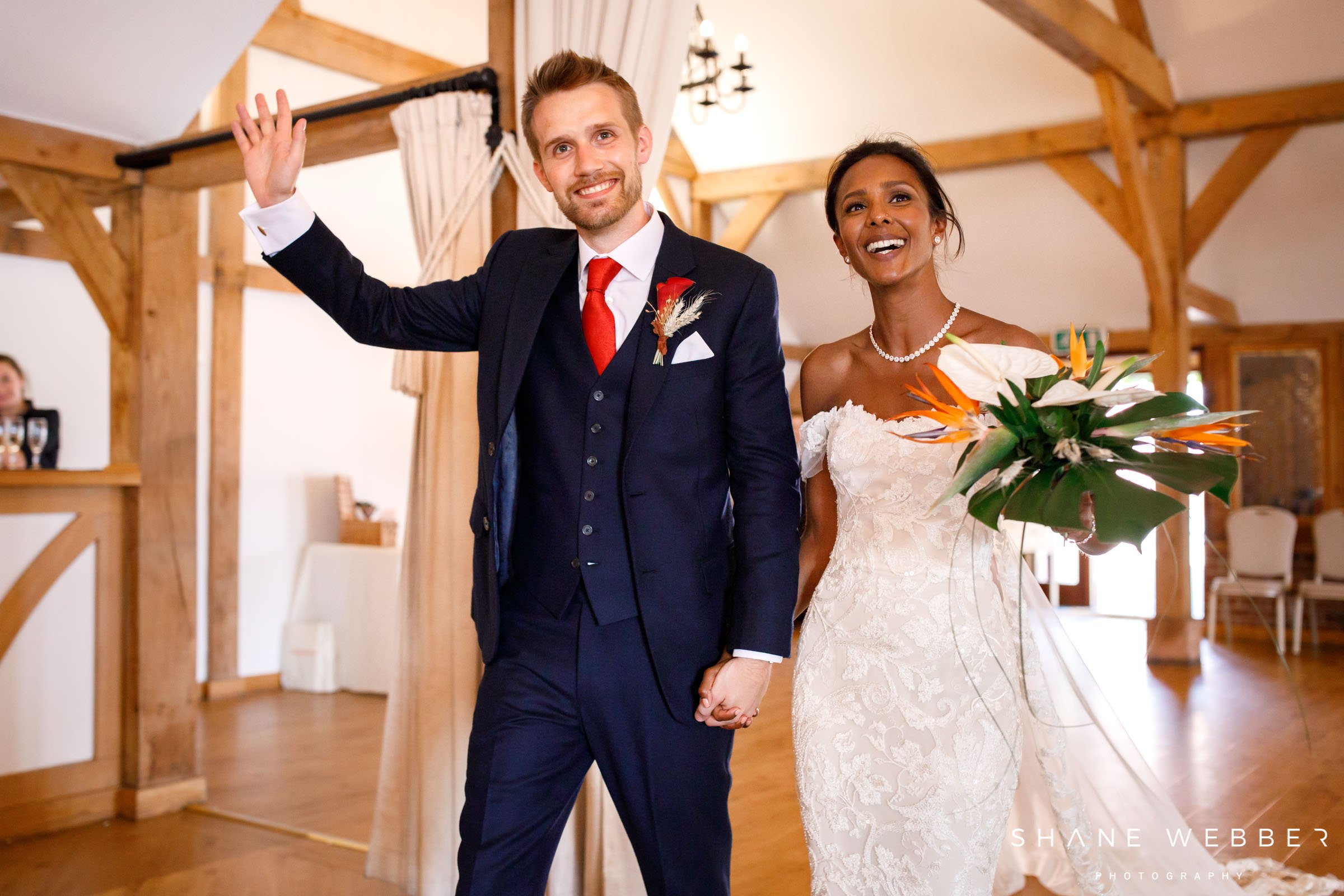 bride and groom walking into their barn wedding reception